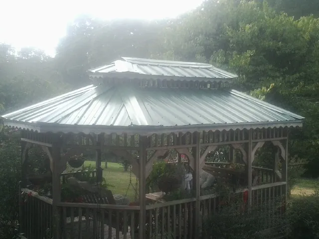 Two tier green metal roof on a garden gazebo in Dexter